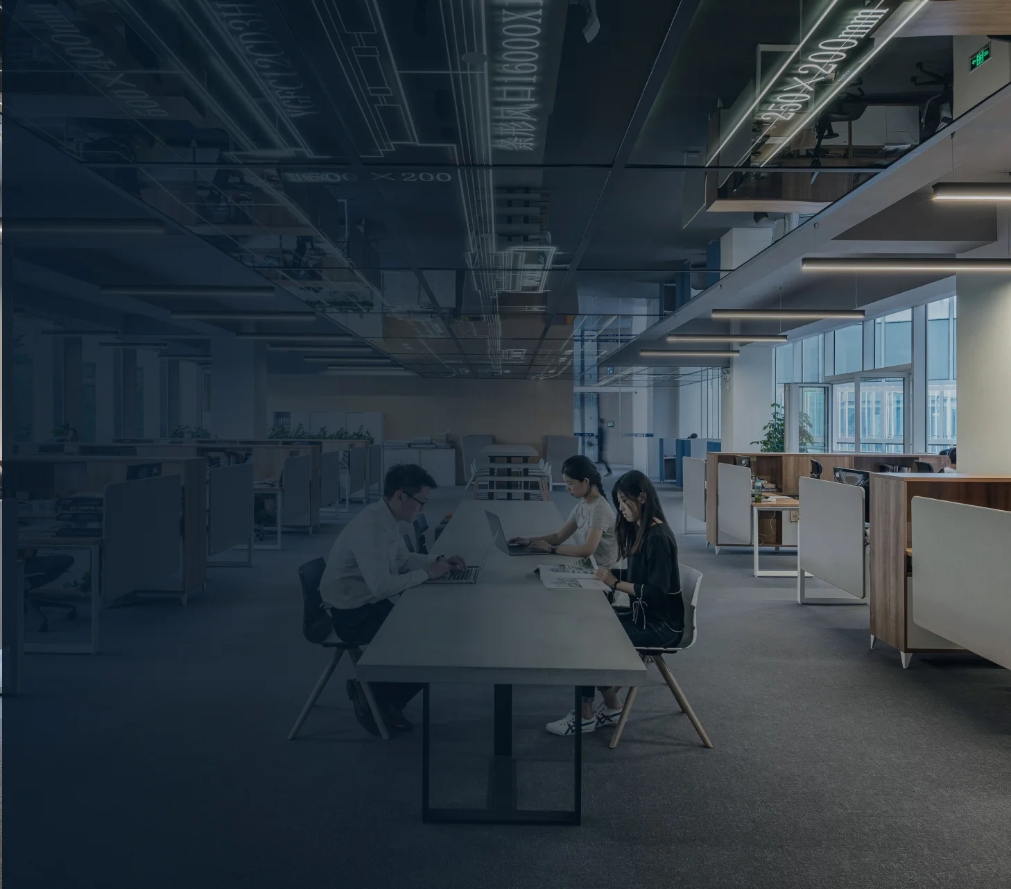 A team collaborating at a shared desk in an open-plan office