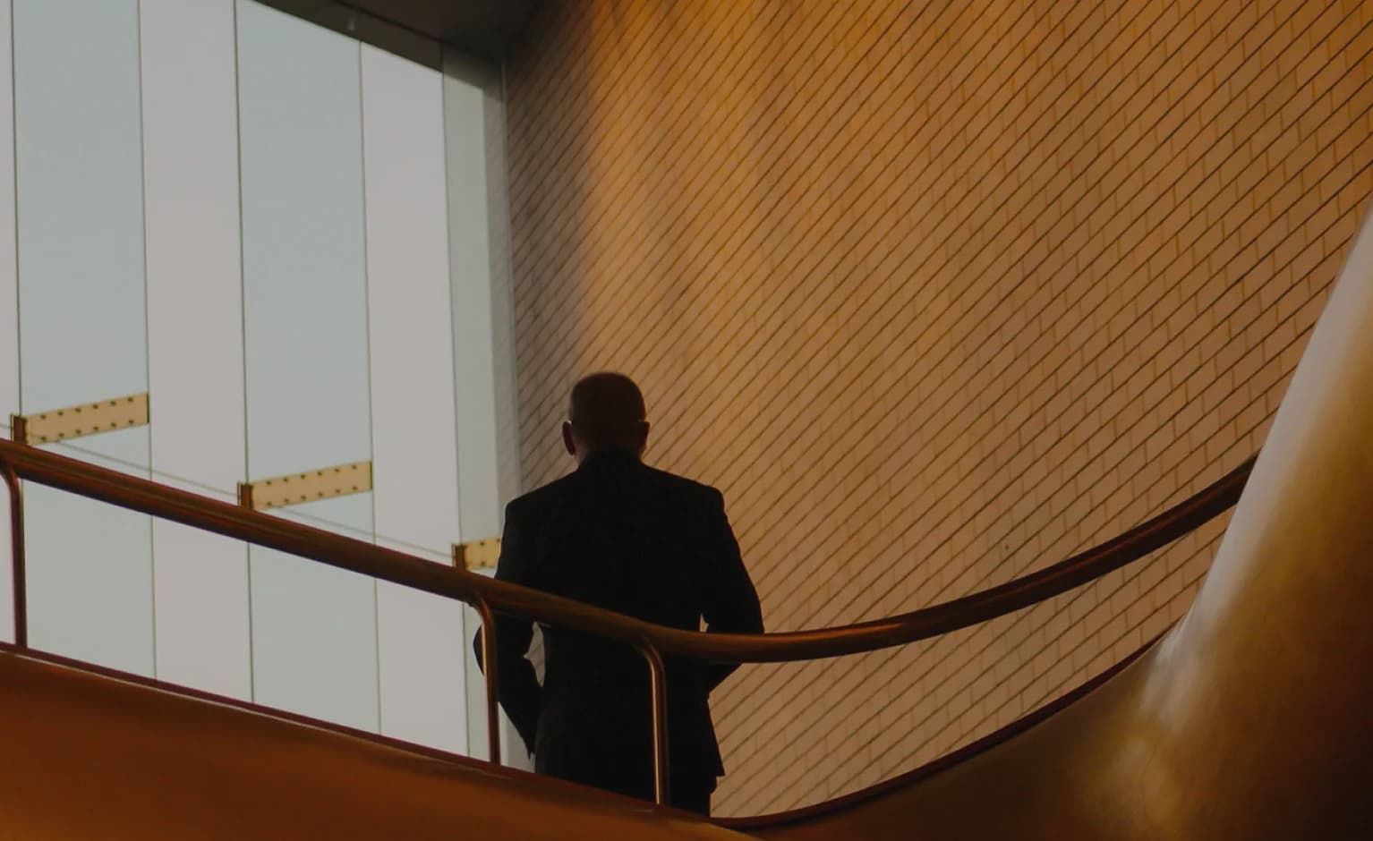 A businessman ascending a staircase in a modern building
